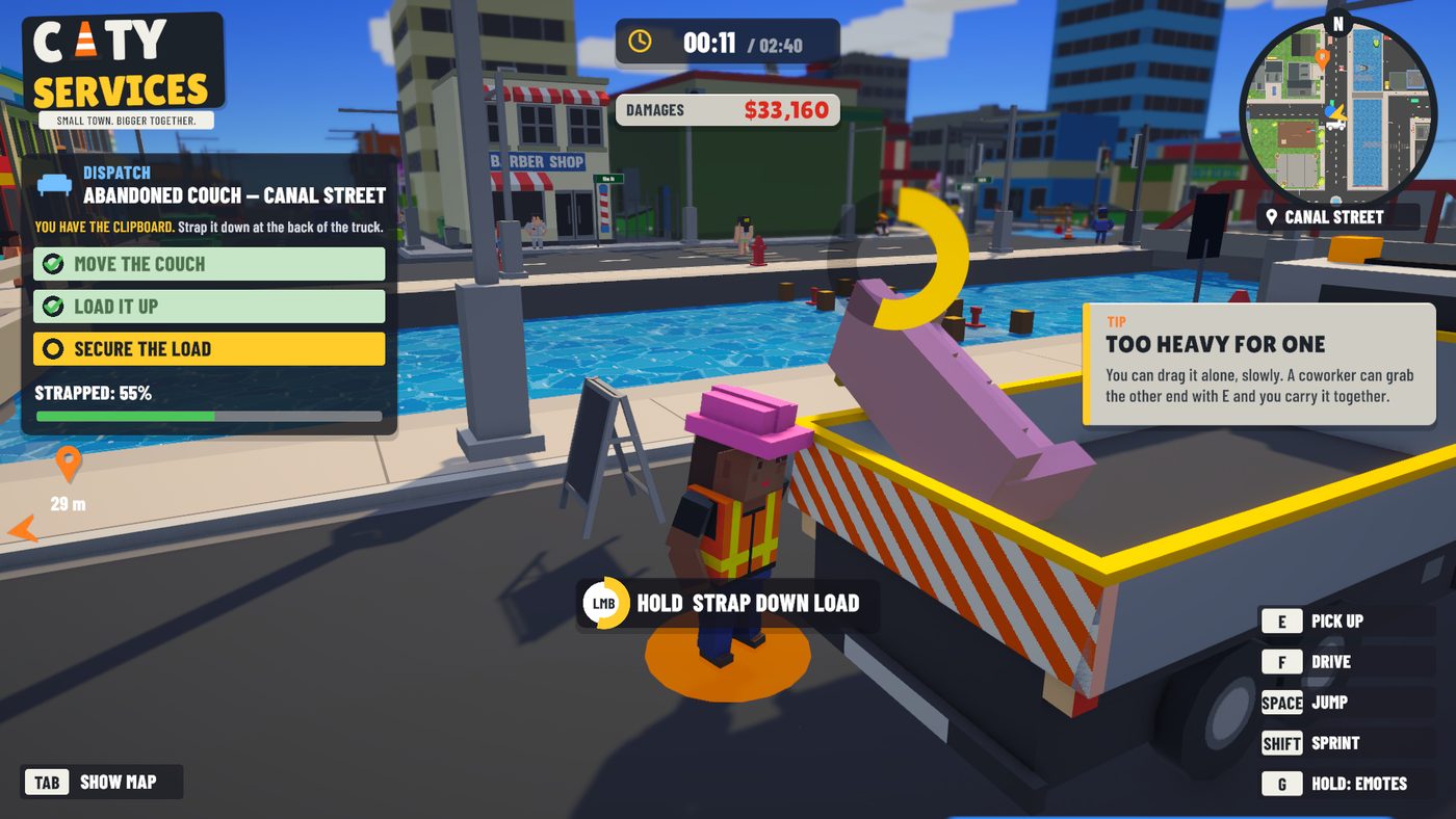 Strapping a couch into the truck on Canal Street, with the canal and the shops behind